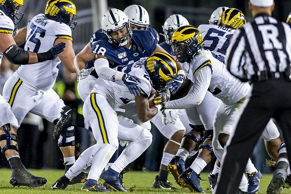 Jon Runyan Jr. (75), Hassan Haskins (25), Nick Eubanks (82), and Cesar Ruiz (51)