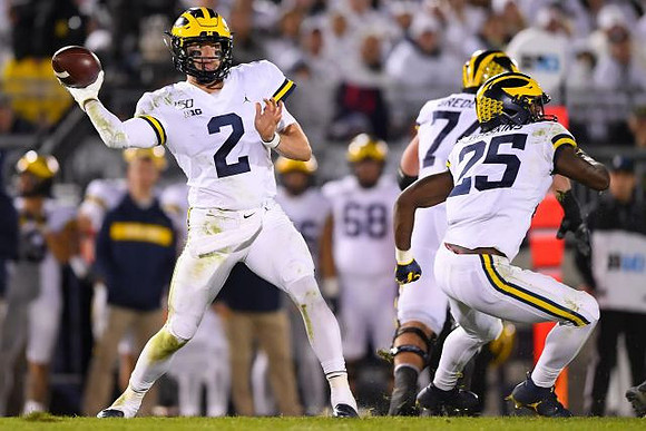 Shea Patterson (2), Ben Bredeson (74), and Hassan Haskins (25)