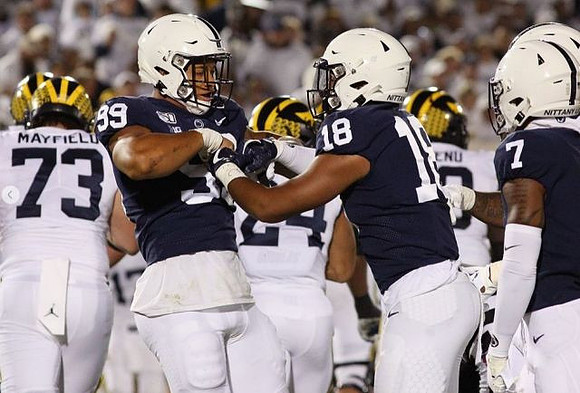 Jalen Mayfield (73), Zach Charbonnet (24), and Michael Onwenu (50)