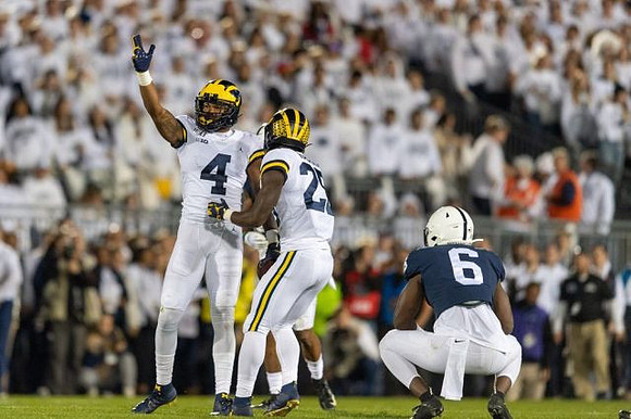Nico Collins (4) and Hassan Haskins (25)