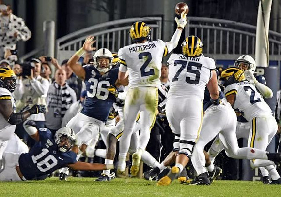 Shea Patterson (2), Jon Runyan Jr. (75), and Zach Charbonnet (24)