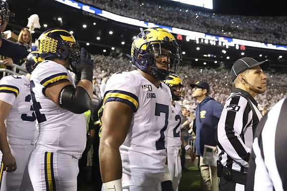 Camaron Cheeseman (33), Ben Bredeson (74), Khaleke Hudson (7), and Jim Harbaugh