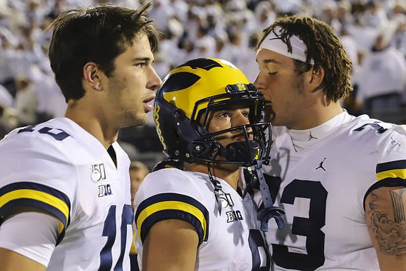 Dylan McCaffrey (10), Ronnie Bell (8), and Jalen Mayfield (73)