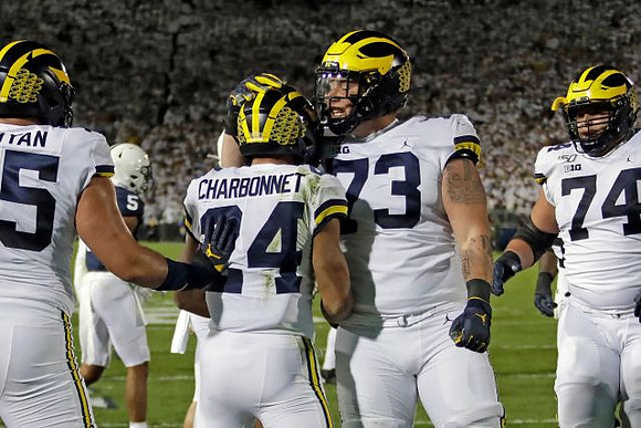 Jon Runyan Jr. (75), Zach Charbonnet (24), Jalen Mayfield (73), and Ben Bredeson (74)