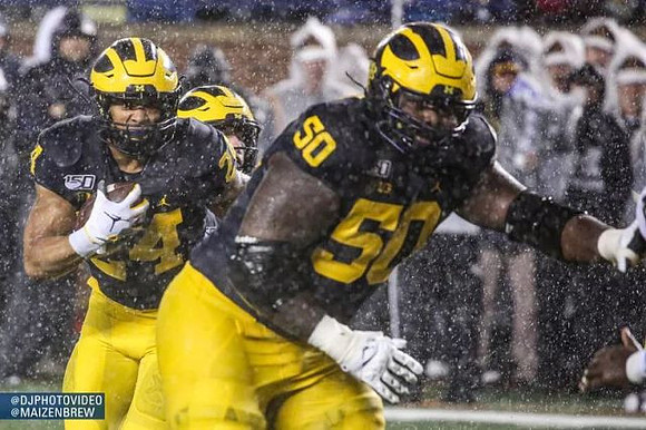 Zach Charbonnet (24) and Michael Onwenu (50)