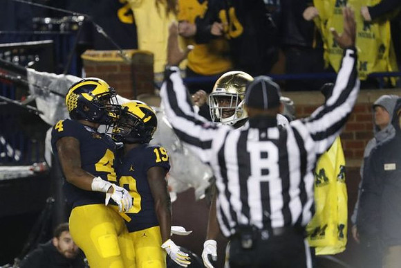 Nico Collins (4) and Mike Sainristil (19)