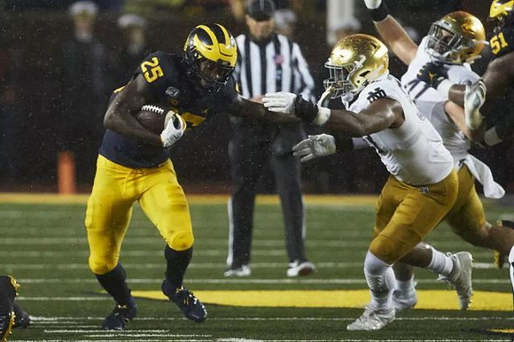 Hassan Haskins (25) and Cesar Ruiz (51)
