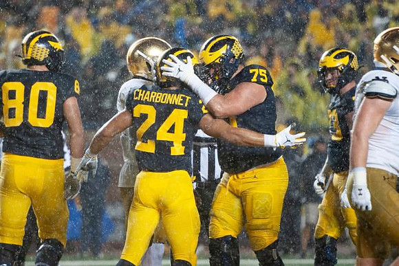 Ryan Hayes (80), Zach Charbonnet (24), Jon Runyan Jr. (75), and Erick All (83)