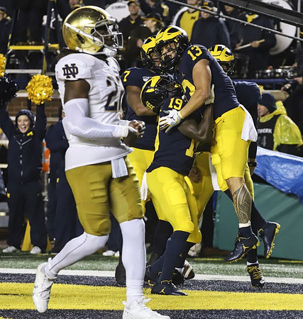 Tarik Black (7), Mike Sainristil (19), and Tru Wilson (13)