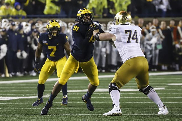 Khaleke Hudson (7) and Taylor Upshaw (91)