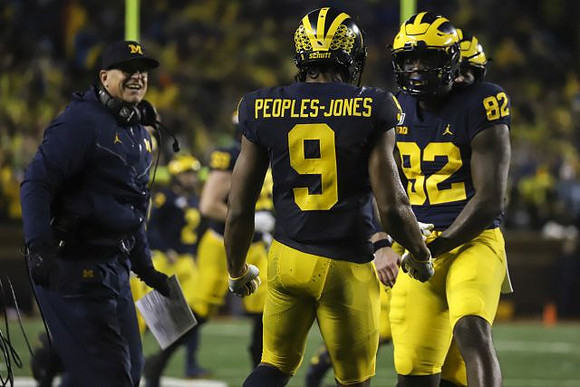 Jim Harbaugh, Donovan Peoples-Jones (9), and Nick Eubanks (82)