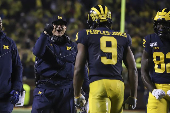 Jim Harbaugh, Donovan Peoples-Jones (9), and Nick Eubanks (82)