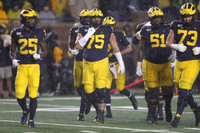 Hassan Haskins (25), Jon Runyan Jr. (75), Shea Patterson (2), Cesar Ruiz (51), and Jalen Mayfield (73)