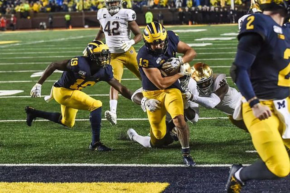 Mike Sainristil (19), Tru Wilson (13), and Shea Patterson (2)