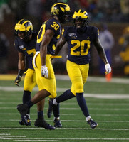 Khaleke Hudson (7), Daxton Hill (30), and Brad Hawkins (20)