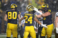 Ryan Hayes (80), Zach Charbonnet (24), and Jon Runyan Jr. (75)