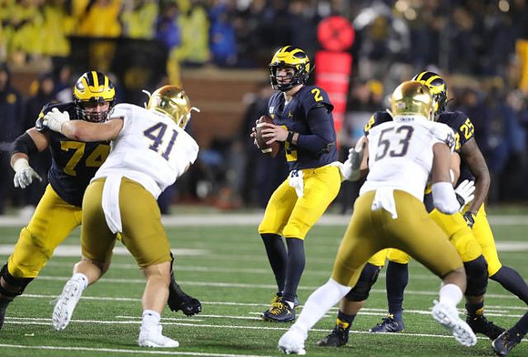Ben Bredeson (74), Shea Patterson (2), Jon Runyan Jr. (75), and Hassan Haskins (25)