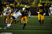 Nick Eubanks (82), Jon Runyan Jr. (75), Hassan Haskins (25), and Michael Onwenu (50)
