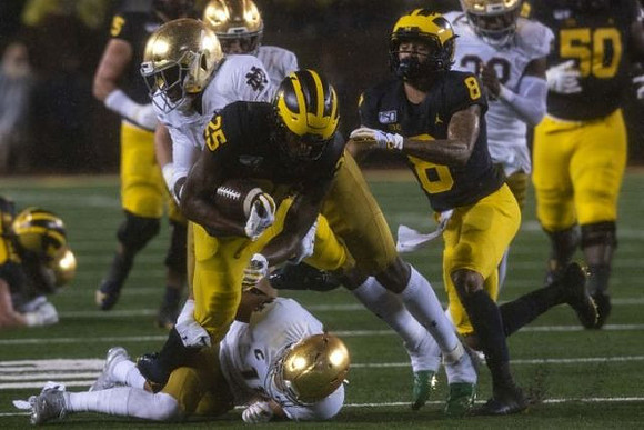 Hassan Haskins (25), Ronnie Bell (8), and Michael Onwenu (50)