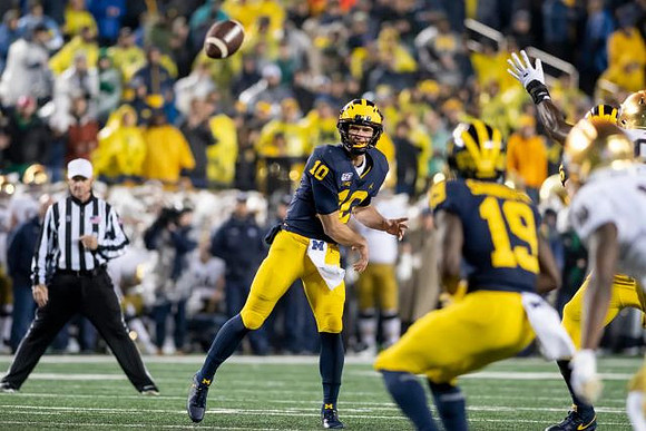 Dylan McCaffrey (10) and Mike Sainristil (19)