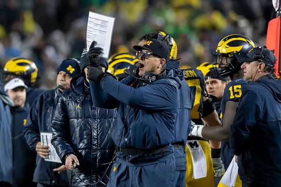 Don Brown, Jim Harbaugh, Giles Jackson (15), and Michael Zordich