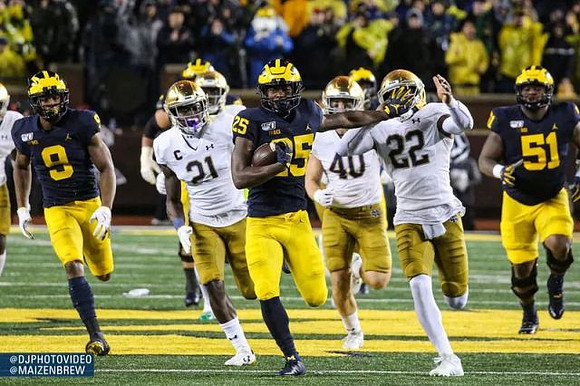 Ronnie Bell (8), Hassan Haskins (25), and Cesar Ruiz (51)