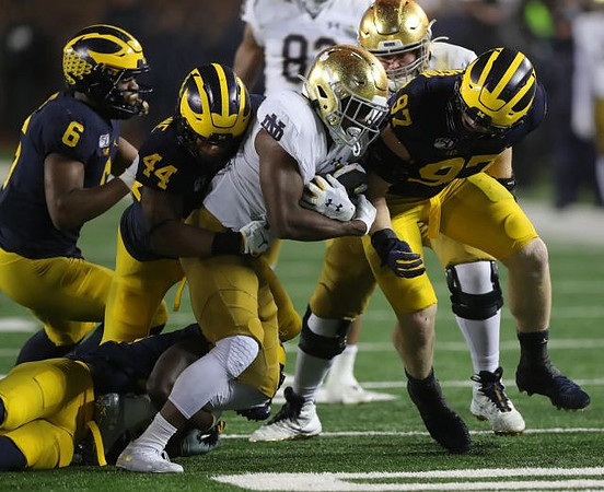 Josh Uche (6), Cameron McGrone (44), and Aidan Hutchinson (97)
