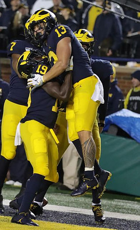 Tarik Black (7), Mike Sainristil (19), Tru Wilson (13), and Shea Patterson (2)