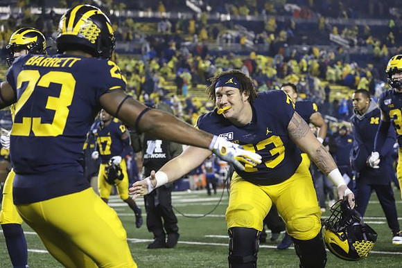 Michael Barrett (23) and Jalen Mayfield (73)
