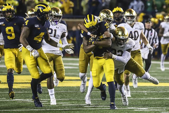 Donovan Peoples-Jones (9), Nico Collins (4), and Hassan Haskins (25)