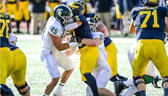 Ryan Hayes (76), Blake Corum (2), Jalen Mayfield (73), and Andrew Stueber (71)