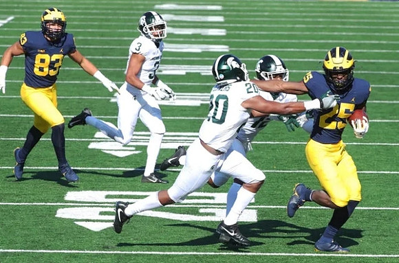 Erick All (83) and Hassan Haskins (25)