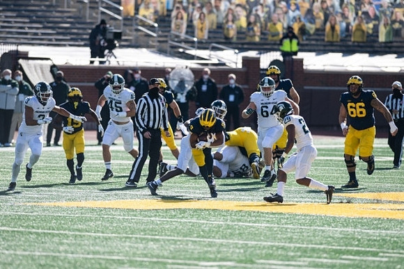 Mike Sainristil (19), A.J. Henning (3), and Chuck Filiaga (66)