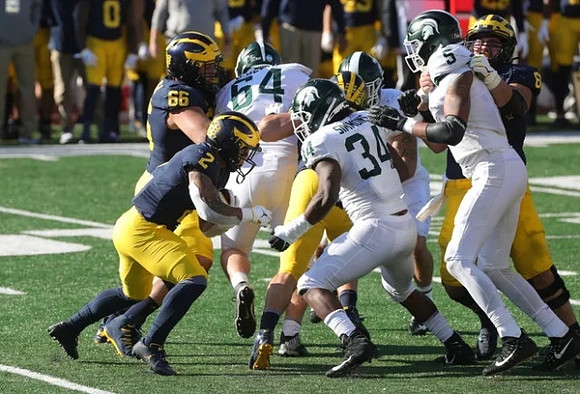 Blake Corum (2) and Chuck Filiaga (66)
