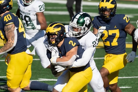 Ben VanSumeren (40), Blake Corum (2), and Hunter Reynolds (27)