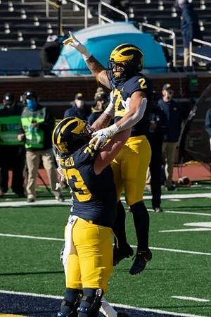 Jalen Mayfield (73) and Blake Corum (2)