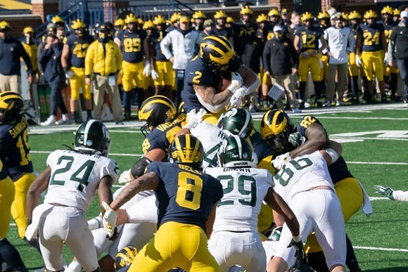 Mike Sainristil (19), Andrew Vastardis (68), Ronnie Bell (8), Blake Corum (2), and Nick Eubanks (82)