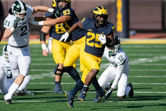 Erick All (83) and Hassan Haskins (25)