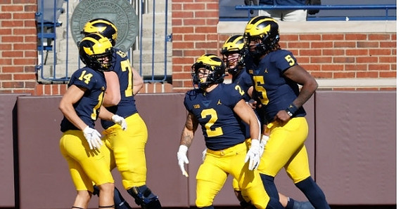 Roman Wilson (14), Blake Corum (2), and Joe Milton (5)