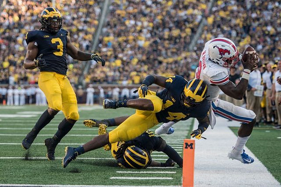 Rashan Gary (3), Josh Metellus (14), and Devin Bush (10)