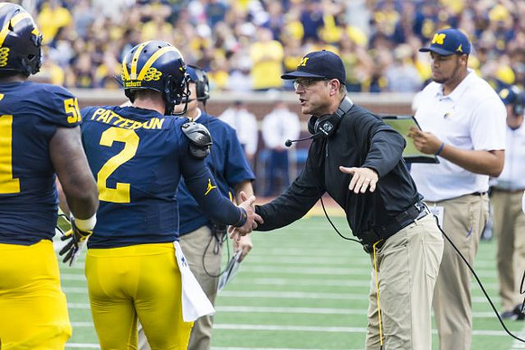 Cesar Ruiz (51), Shea Patterson (2), and Jim Harbaugh