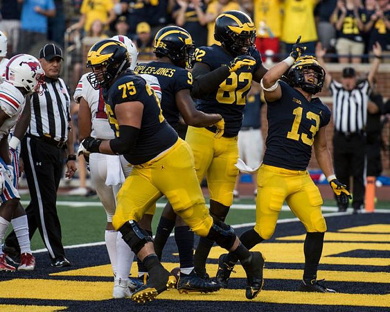 Jon Runyan Jr. (75), Donovan Peoples-Jones (9), Nick Eubanks (82), and Tru Wilson (13)