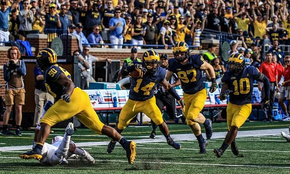 Michael Dwumfour (50), Josh Metellus (14), Aidan Hutchinson (97), and Devin Bush (10)