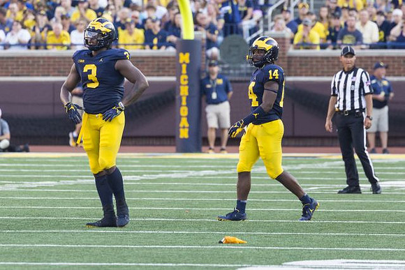 Rashan Gary (3) and Josh Metellus (14)
