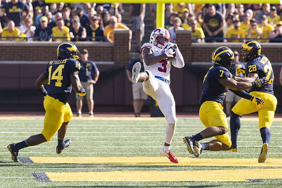 Josh Metellus (14), Khaleke Hudson (7), and Brandon Watson (28)