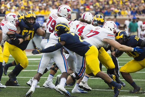 Bryan Mone (90), Khaleke Hudson (7), and Devin Bush (10)