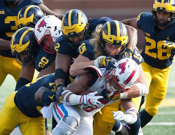 Bryan Mone (90), Josh Metellus (14), Carlo Kemp (2), Chase Winovich (15), and Brandon Watson (28)