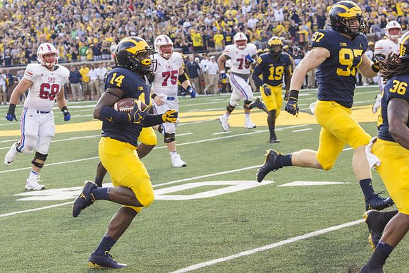Josh Metellus (14), Kwity Paye (19), Aidan Hutchinson (97), and Devin Gil (36)