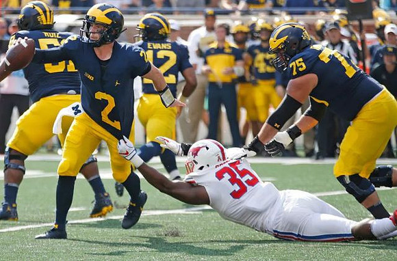 Shea Patterson (2), Cesar Ruiz (51), Chris Evans (12), and Jon Runyan Jr. (75)