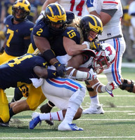 Khaleke Hudson (7), Josh Metellus (14), Carlo Kemp (2), and Chase Winovich (15)